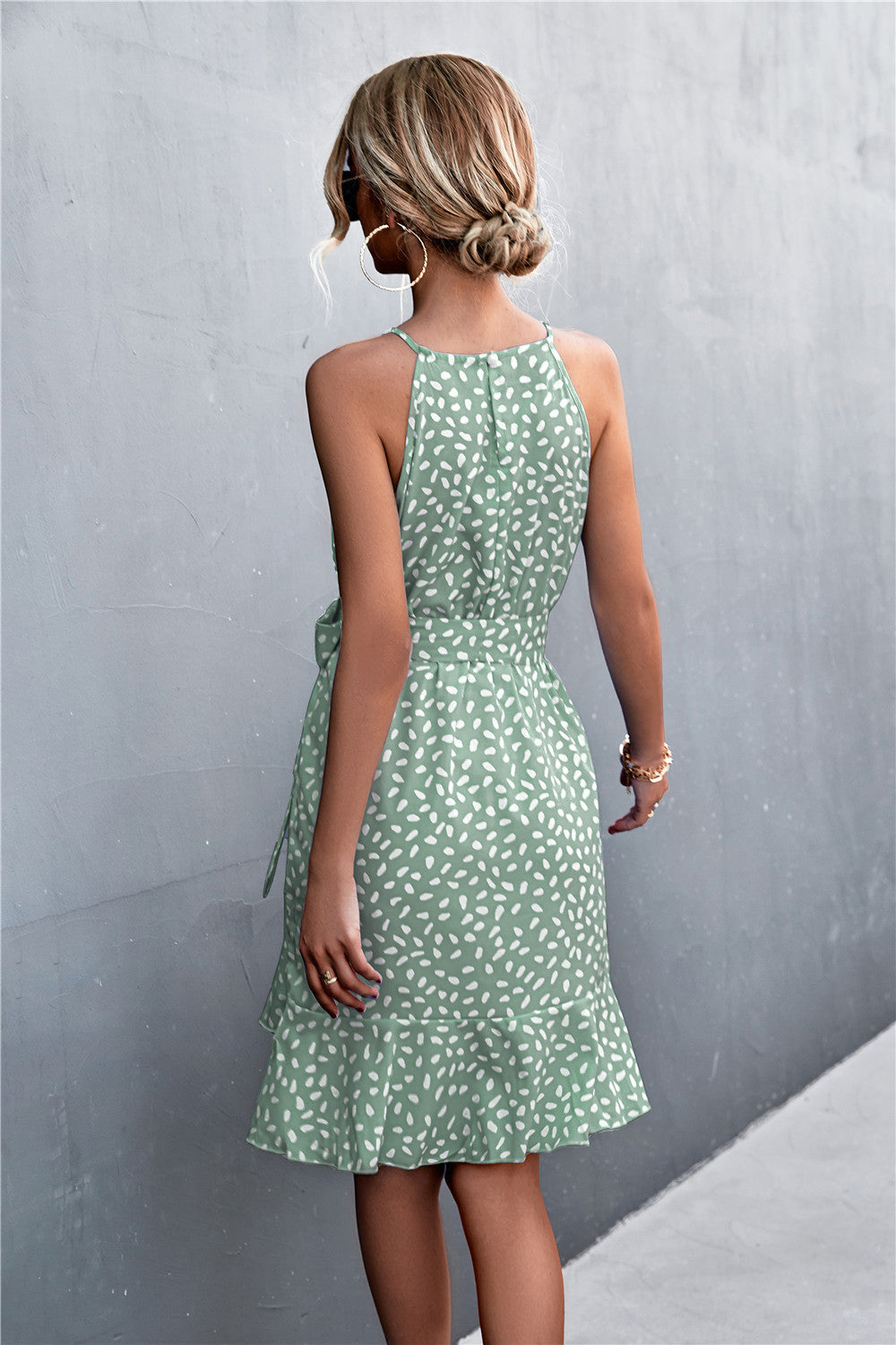 Dotted halter neck mini dress in Gum Leaf green with ruffle hem and tie waist.