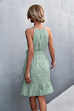 Dotted halter neck mini dress in Gum Leaf green with ruffle hem and tie waist.