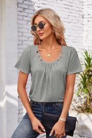 Gray short sleeve top with gathered yoke and button trim neckline