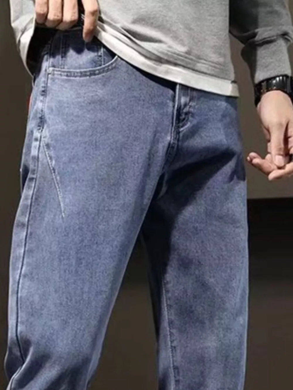 Relaxed fit straight leg jeans in medium wash cotton, showing front pockets and fly.