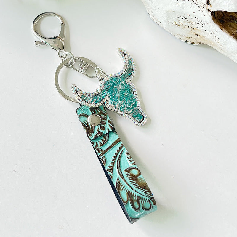 Turquoise embossed leather and crystal bull keychain with hair-on hide detail.