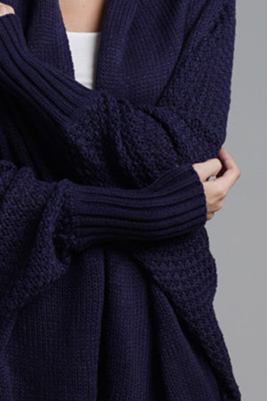 Navy acrylic batwing cardigan with textured sleeves and ribbed cuffs.