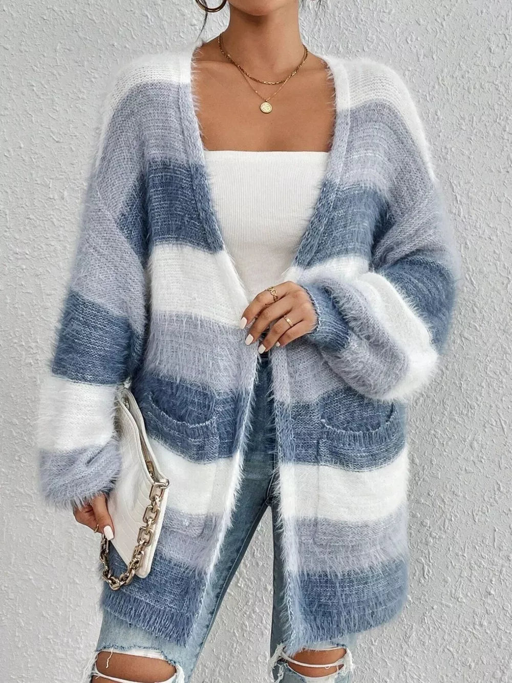 Textured stripe open front cardigan in blue and white fuzzy acrylic with pockets.