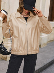 Khaki faux leather bomber jacket with zip front and elastic cuffs.