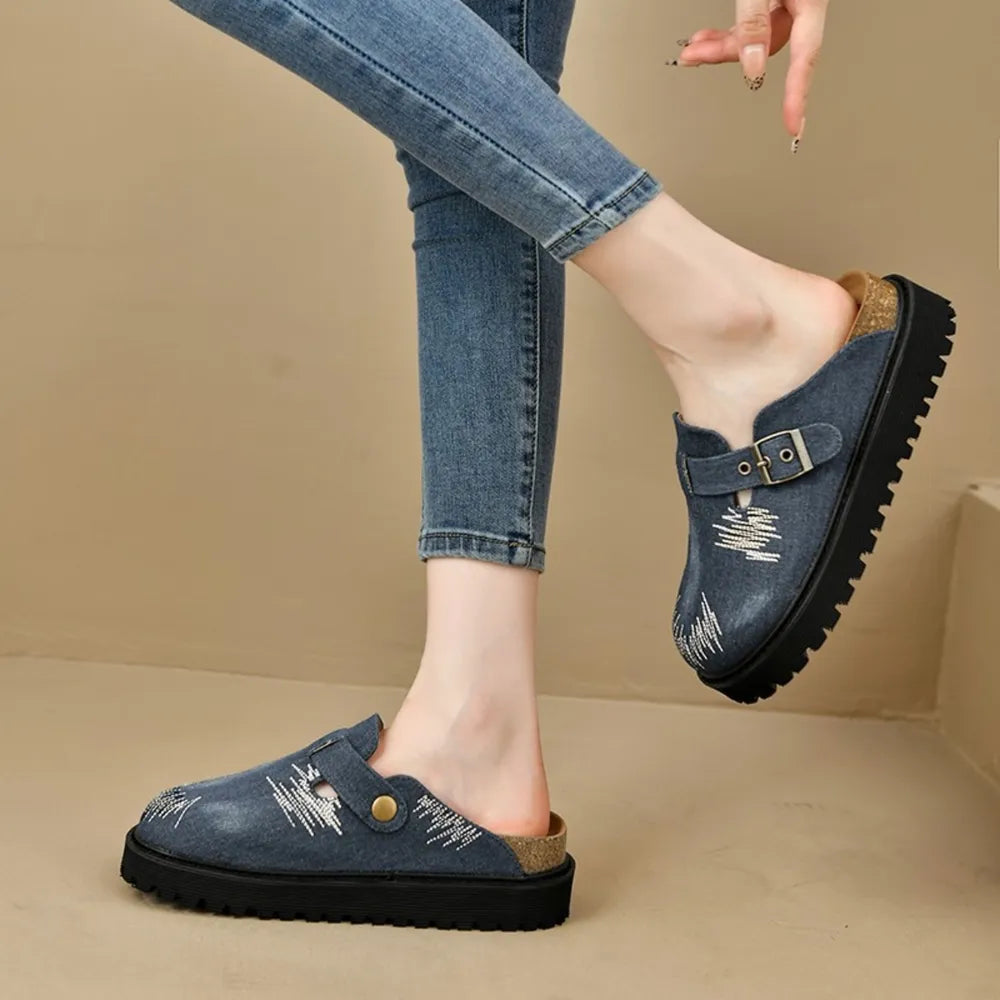Embroidered denim clogs with buckle detail and platform sole.