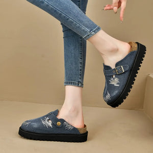 Embroidered denim clogs with buckle detail and platform sole.