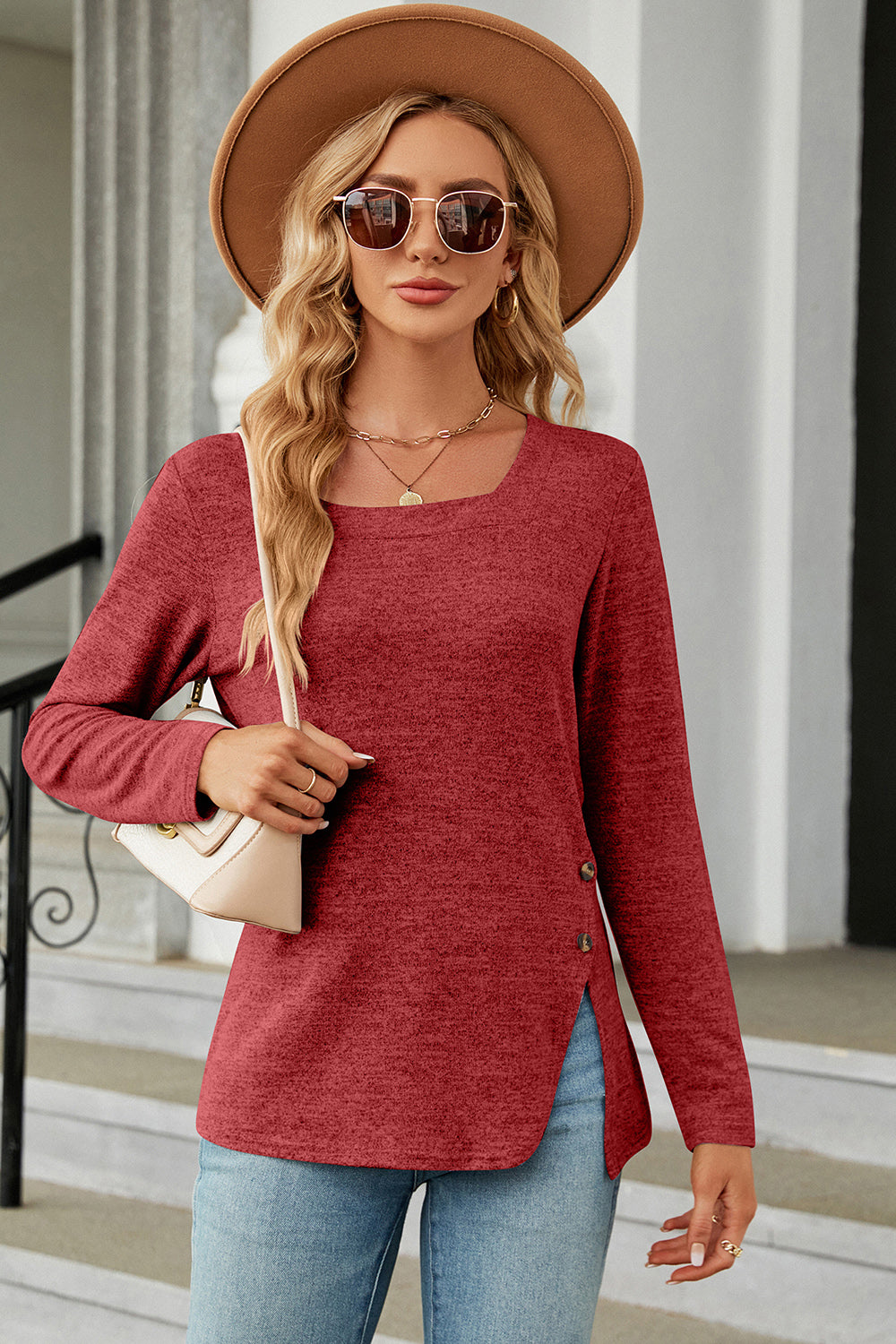 Rust asymmetric long sleeve top with square neck and button detail on side slit.