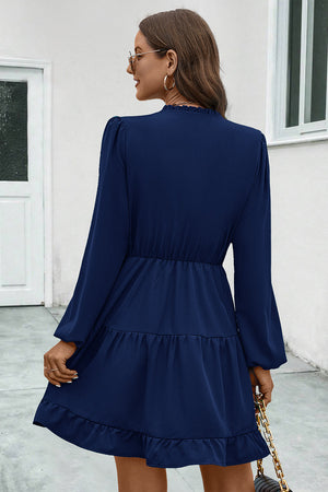 Navy tiered ruffle sleeve mini dress with smocked waist and ruffled hem.