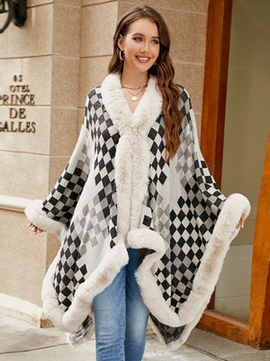 Checkered cape with faux fur trim in black and white, featuring a V-neck and open front.