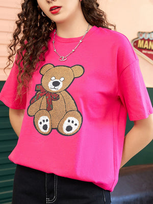Pink graphic tee with teddy bear and red bow detail