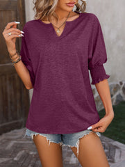 Deep purple blouse with keyhole neckline and shirred sleeves.