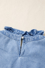 Light wash denim blouse with frilled collar and button keyhole detail.