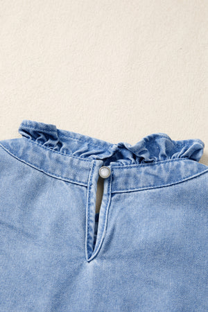 Light wash denim blouse with frilled collar and button keyhole detail.
