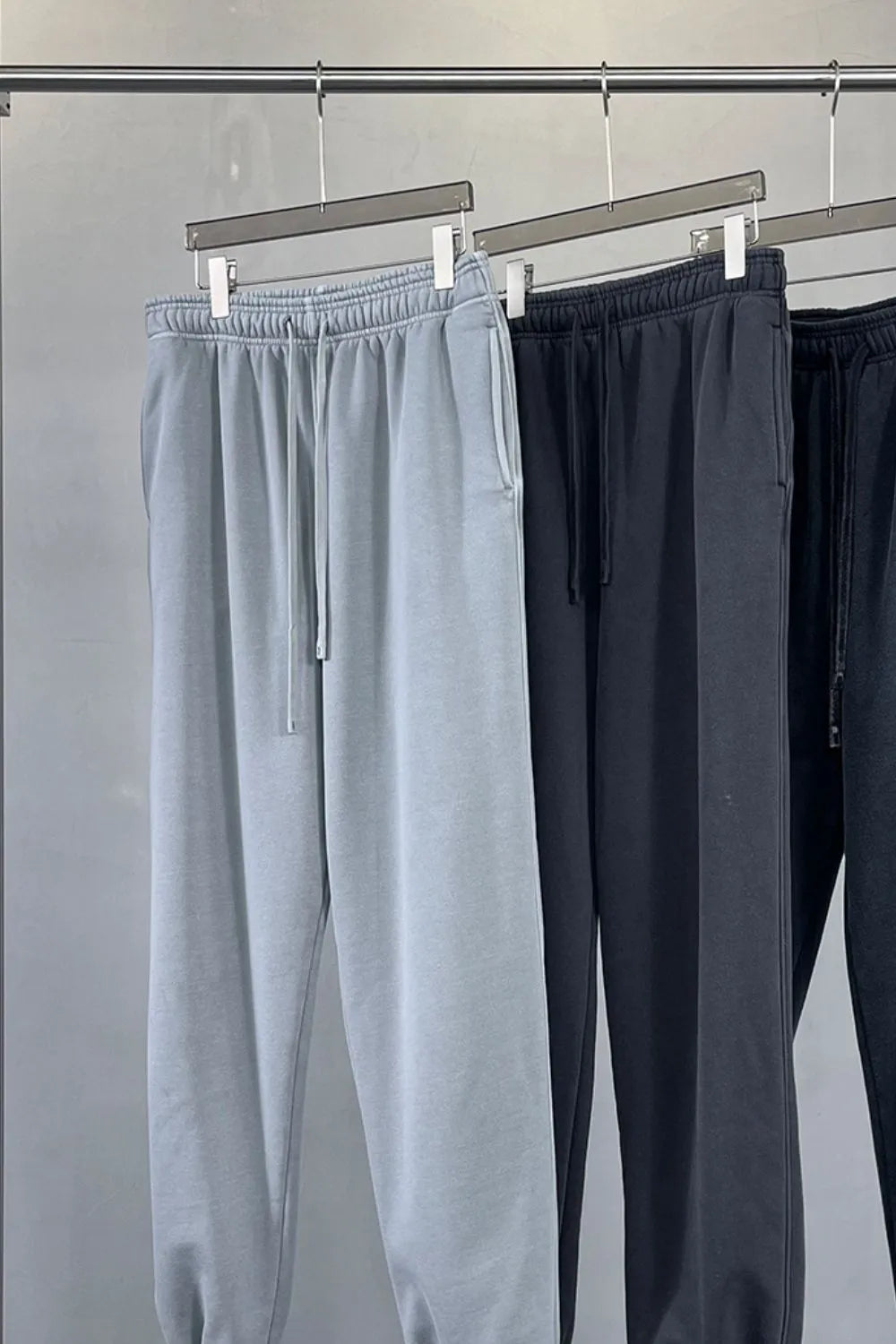 Relaxed fit gray sweatpants with drawstring waist and pockets.