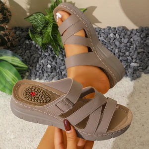 Khaki multi-strap wedge sandals with adjustable buckle and criss-cross detail.