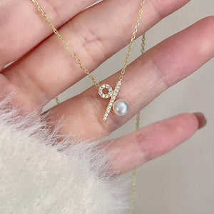 Gold necklace with percentage pendant, cubic zirconia and pearl detail
