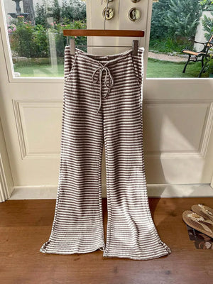 Maternity wide leg trousers in dark brown and white stripe pattern with drawstring waist.