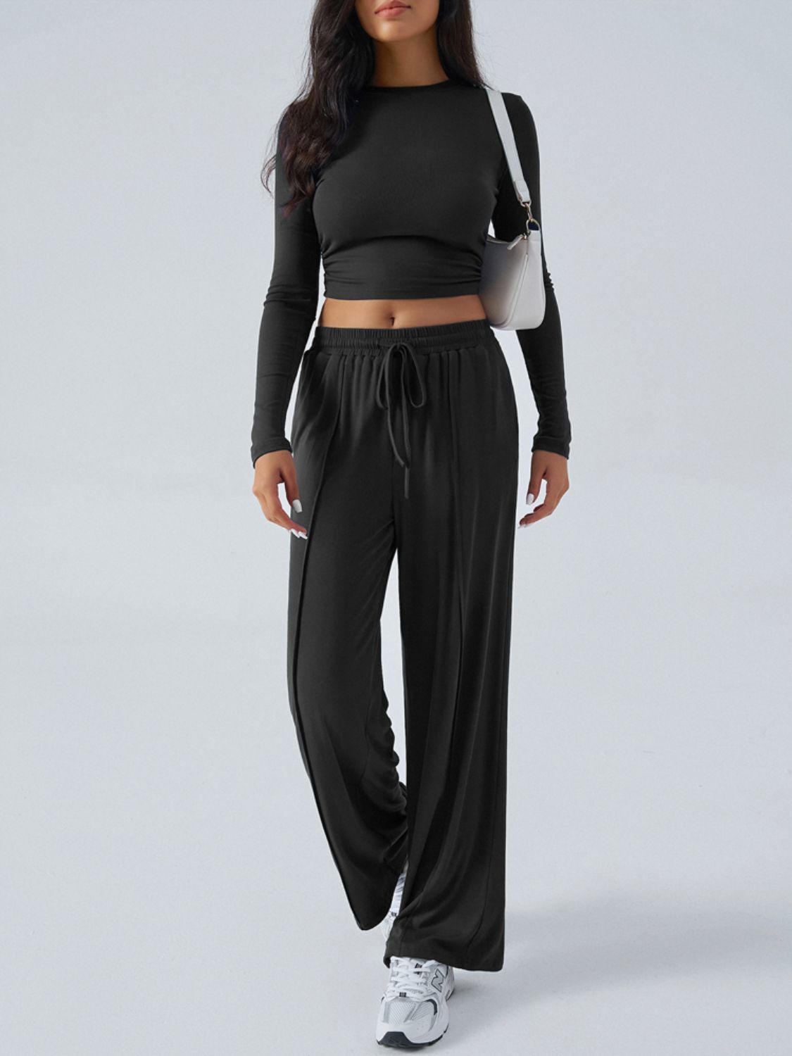Black ribbed knit crop top and wide leg pants set with drawstring waist.