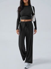 Black ribbed knit crop top and wide leg pants set with drawstring waist.