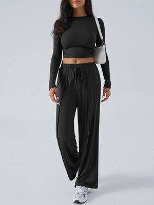 Black ribbed knit crop top and wide leg pants set with drawstring waist.
