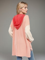 Waffle knit colorblock tunic with contrast red hood and cream sleeves.
