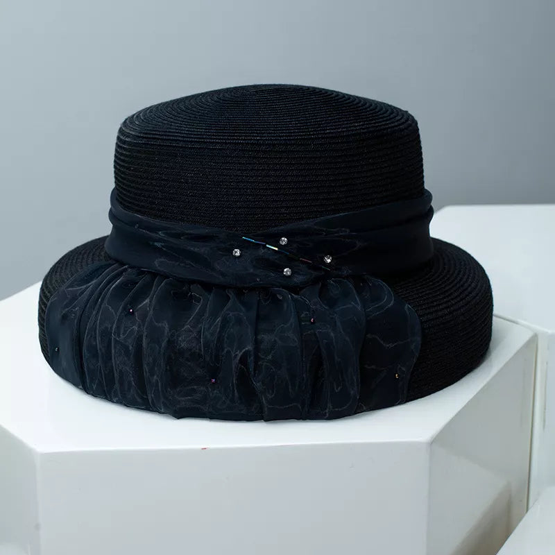 Black wheat straw cloche hat with ribbon and jeweled embellishments