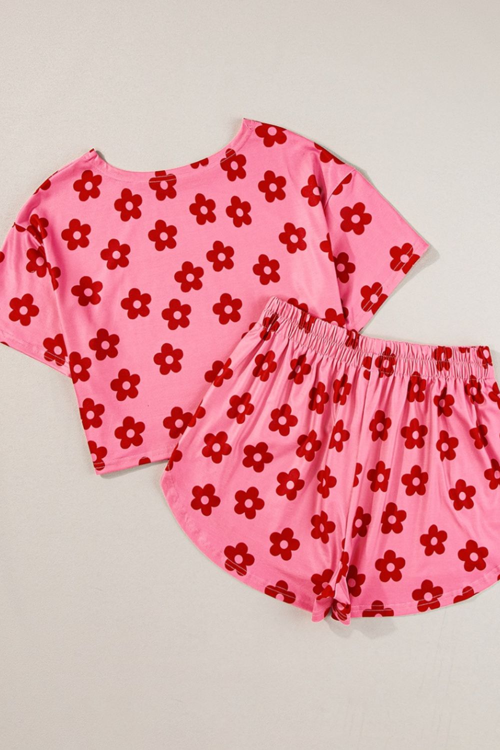 Retro floral crop top and shorts set in coral pink with red flowers.