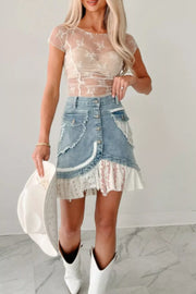 Beige sheer floral embroidered ruched maternity shirt with short sleeves.