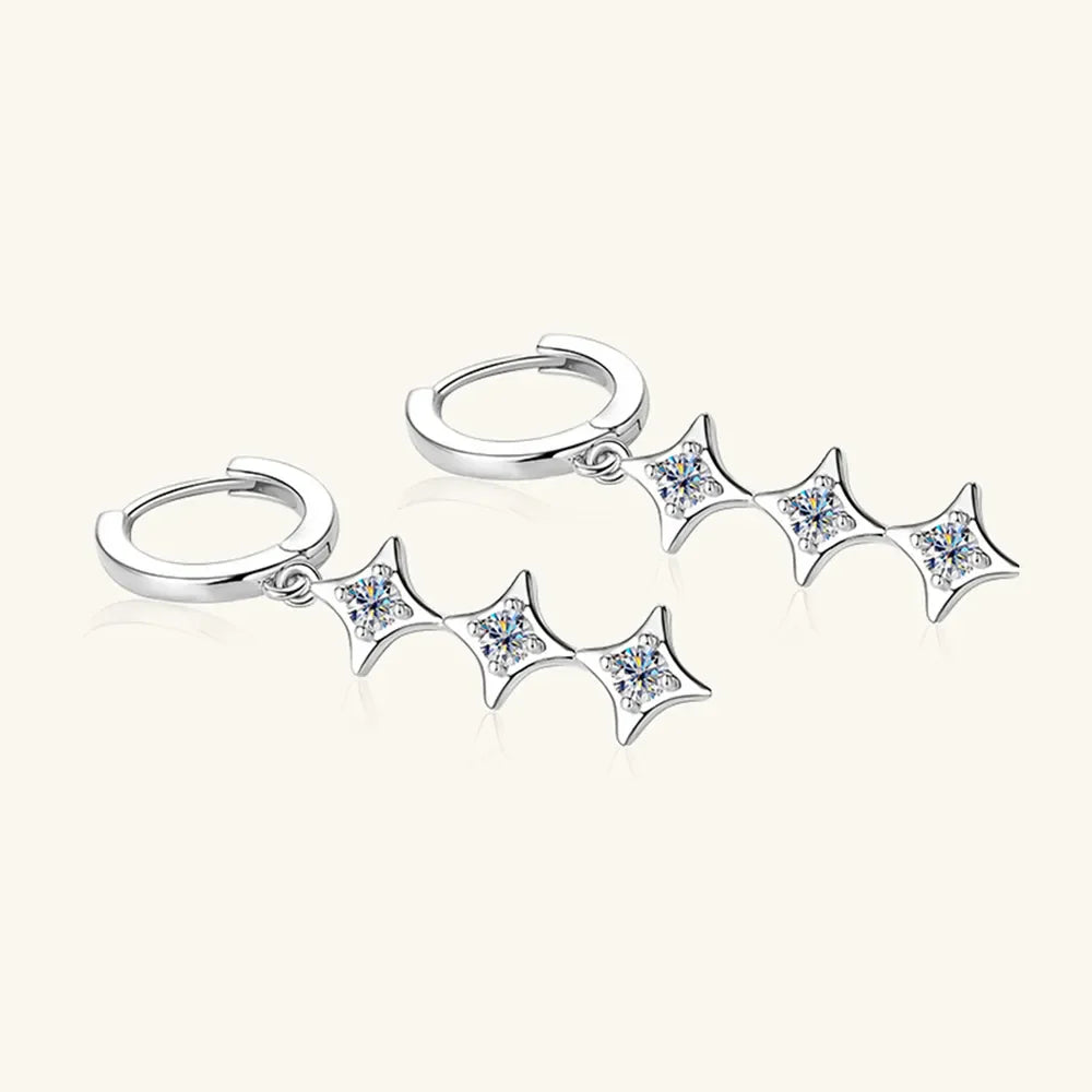 Silver hoop earrings with cascading diamond star charms.
