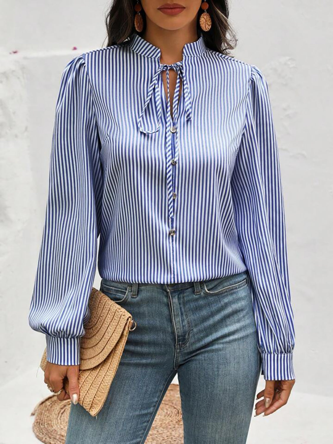 Blue stripe blouse with puffed sleeves and keyhole tie neck.