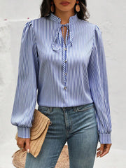 Blue stripe blouse with puffed sleeves and keyhole tie neck.