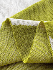 Green wavy knit midi dress with spaghetti straps, close-up detail.