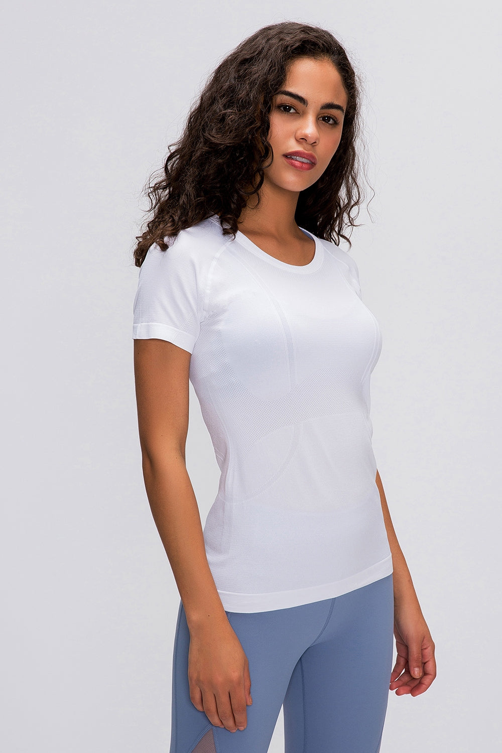 White seamless active tee with short sleeves and textured detail.