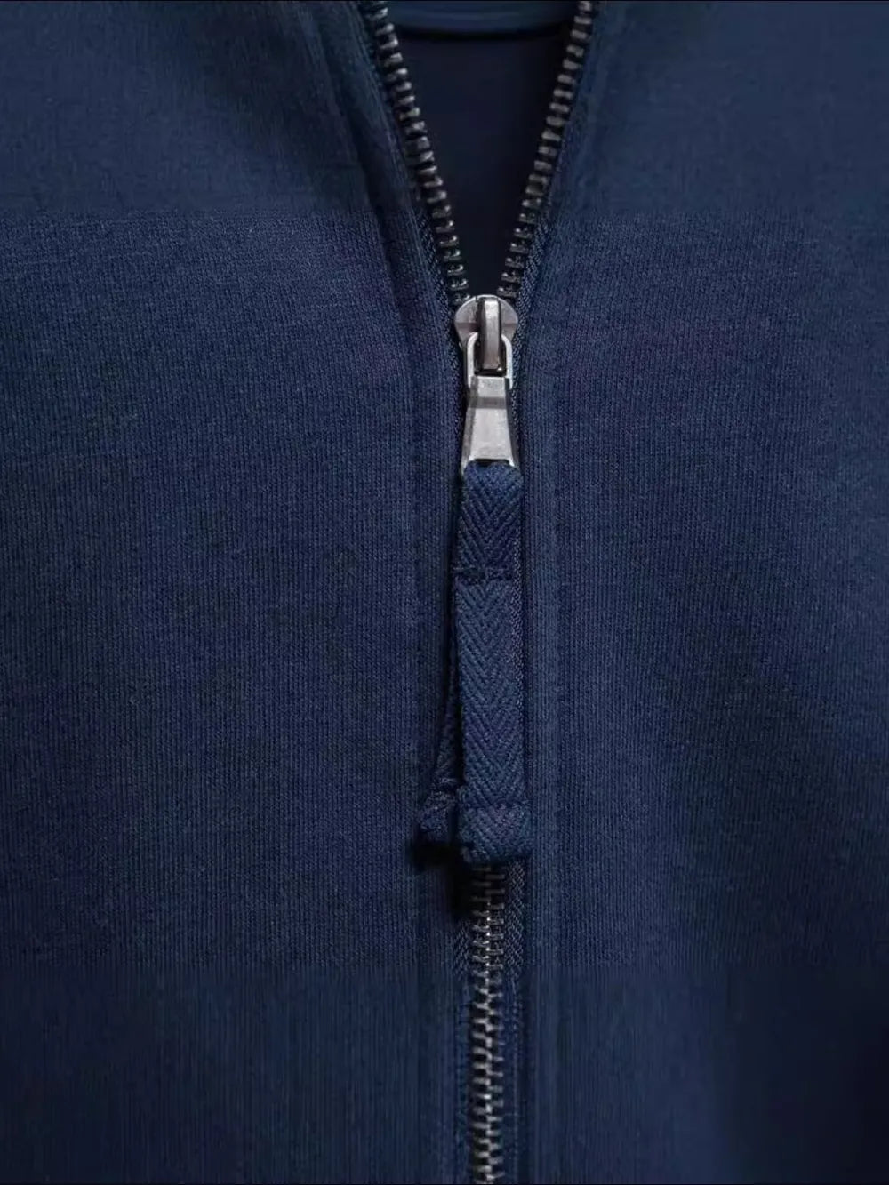 Navy track jacket with full zip and chevron pull tab detail.