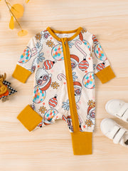Baby one-piece with holiday disco ball, candy cane, and Santa print, yellow trim, long sleeves.