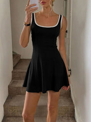 Black A-line mini dress with white trim and wide straps