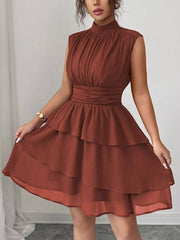 Sleeveless ruffle tiered dress in dark red with ruched waist and mock neck.