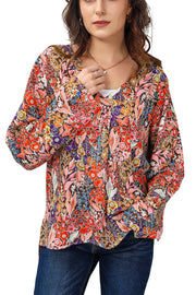 Painterly floral oversized blouse with flared sleeves and V-neck.