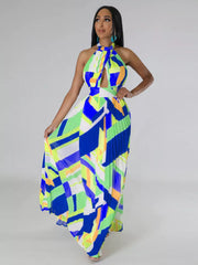 Halter neck maxi dress with geometric print, cutout, and pleated skirt.