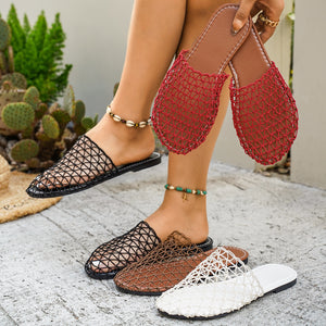 Breathable woven mule sandals in black, dark brown, and white with red pair held.