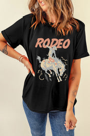 Black rodeo graphic tee with rolled sleeves and a distressed cowboy on a bucking horse design.