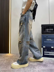 Heavily distressed vintage wide-leg jeans in blue denim with ripped details.