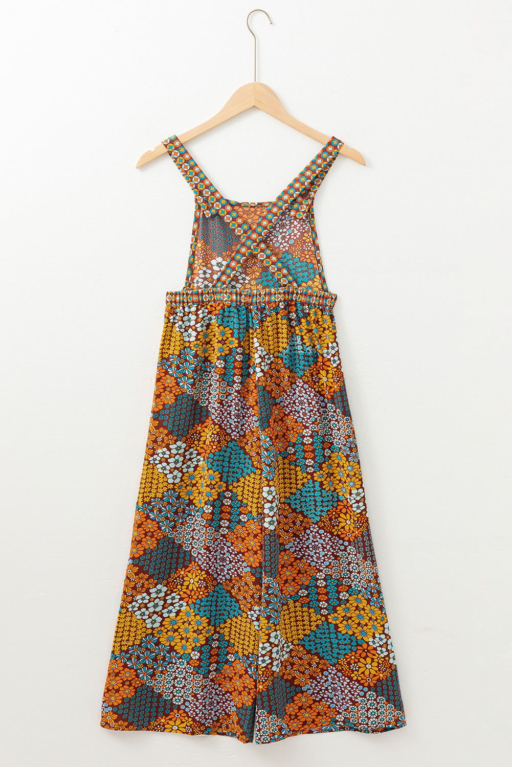 Floral patchwork culotte jumpsuit with wide legs and a cinched waist.