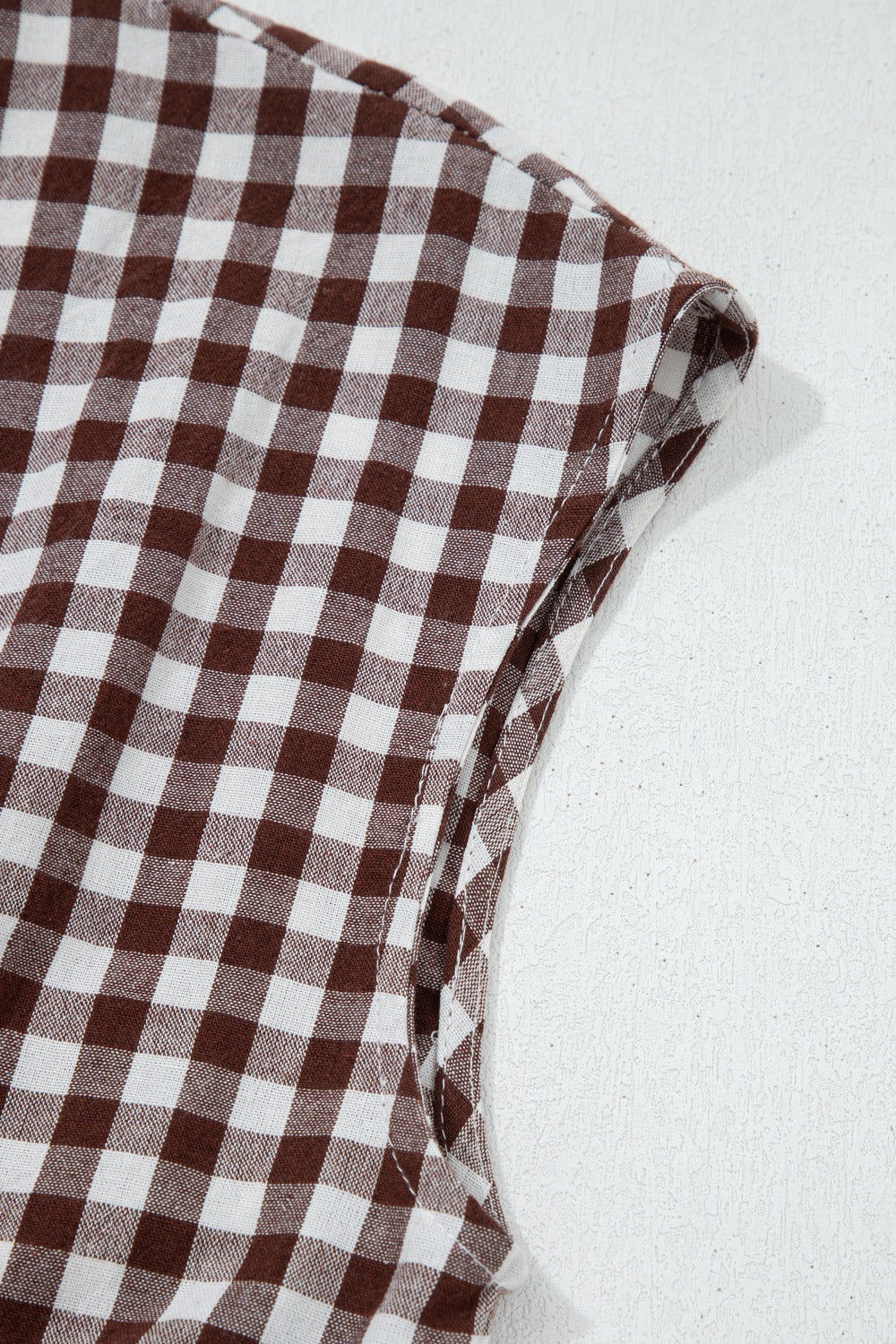 Gingham zip-front midi dress in taupe cotton, close-up of sleeve detail.