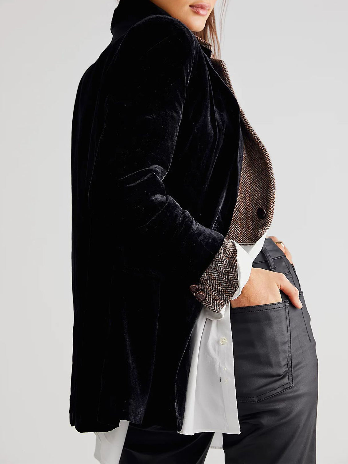 Black velvet double-breasted blazer with patch pockets and herringbone trim cuffs.
