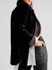 Black velvet double-breasted blazer with patch pockets and herringbone trim cuffs.
