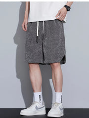 Men's dark gray textured drawstring boxer shorts with side slits.