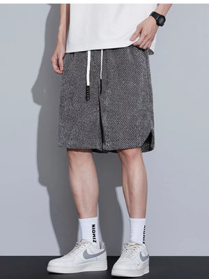 Men's dark gray textured drawstring boxer shorts with side slits.
