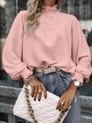Dusty pink textured puff sleeve blouse with smocked neck and cuffs
