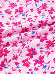 Boho floral print blouse in fuchsia pink with bubble sleeves and a light pink background.